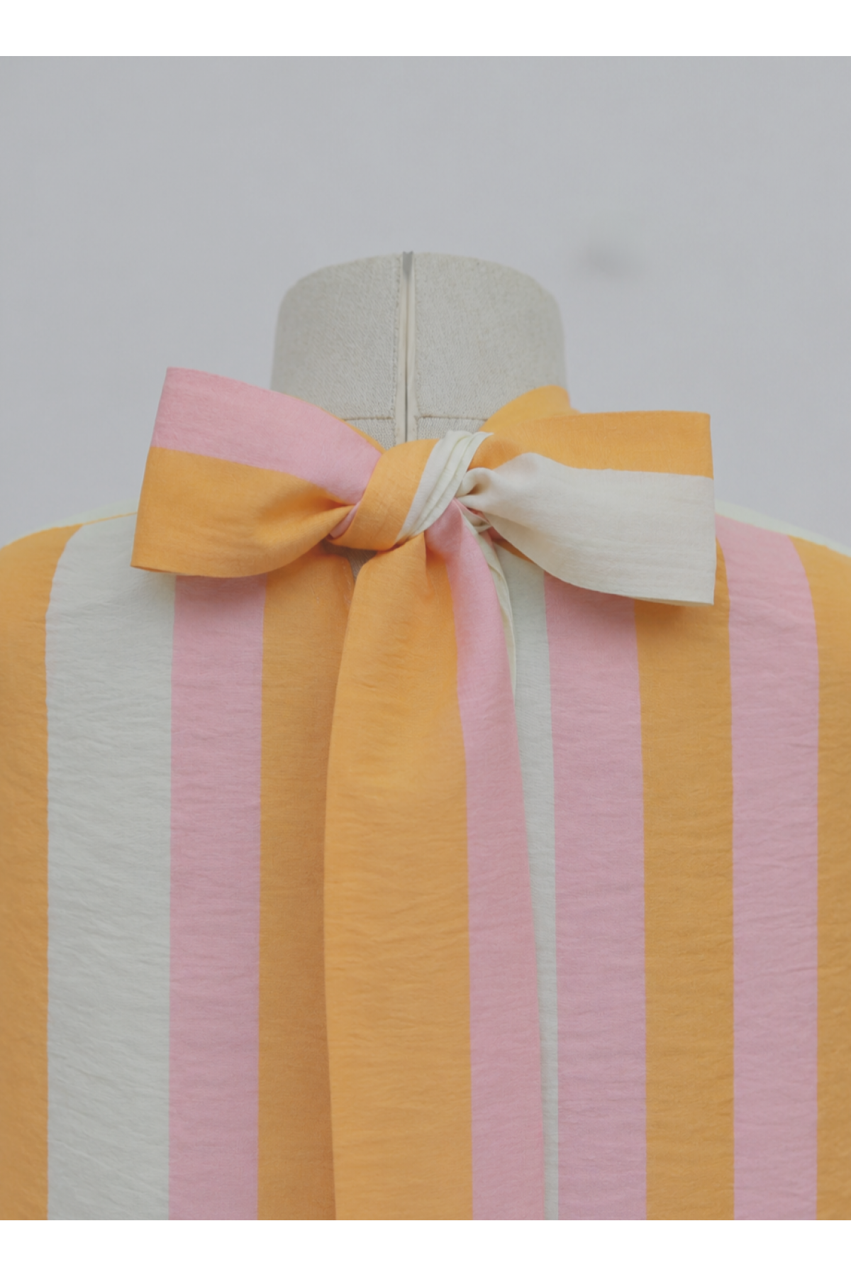 Loose-fitting blouse with thick stripes and Spanish-style sleeves, tie-neckline at the back. -Orange