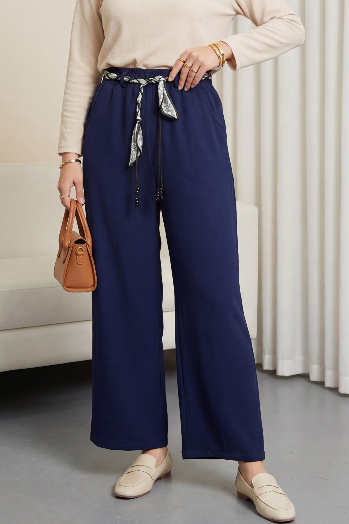 Wide-leg linen trousers with elasticated waist, belt, and pockets. -Navy blue