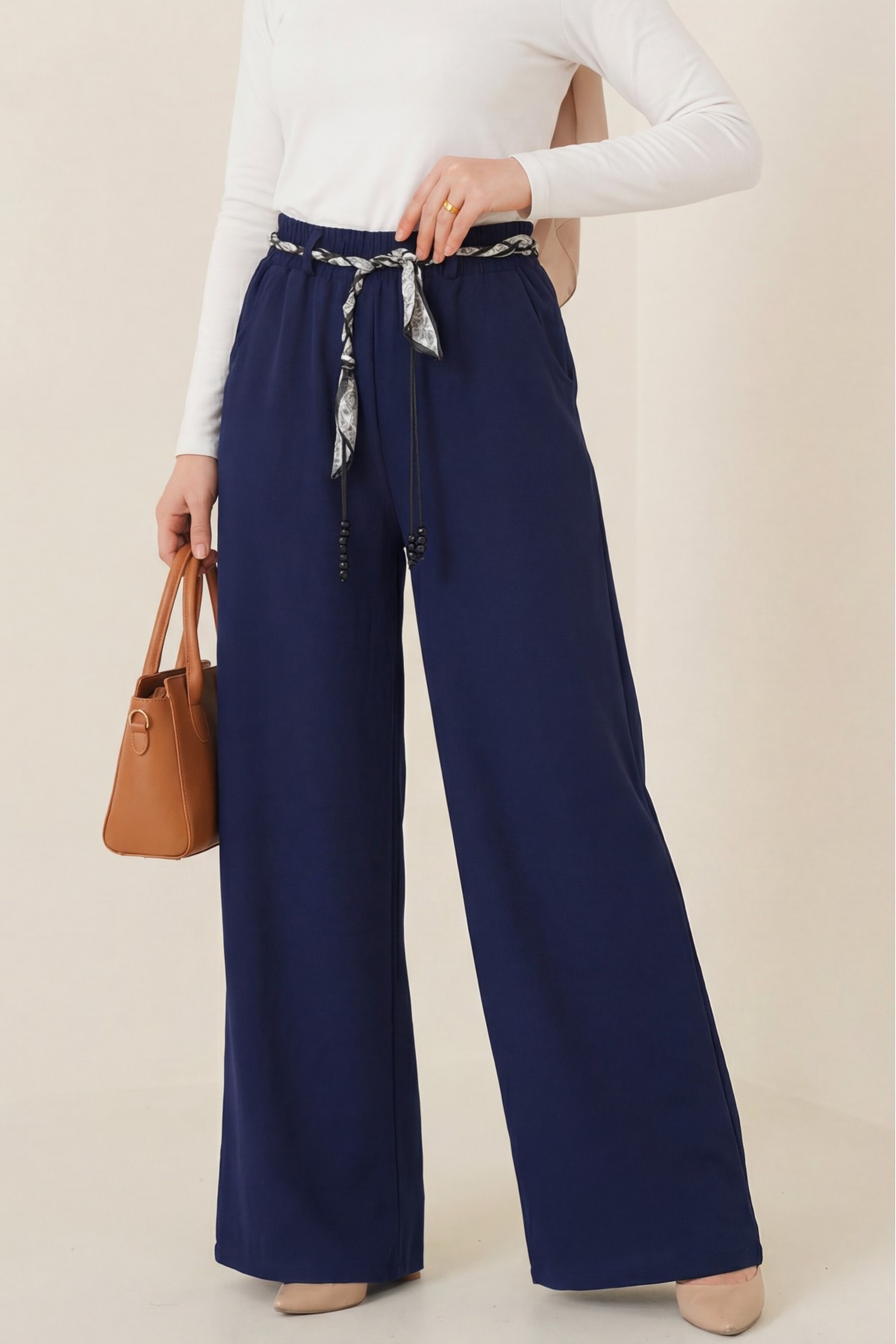 Wide-leg linen trousers with elasticated waist, belt, and pockets. -Navy blue