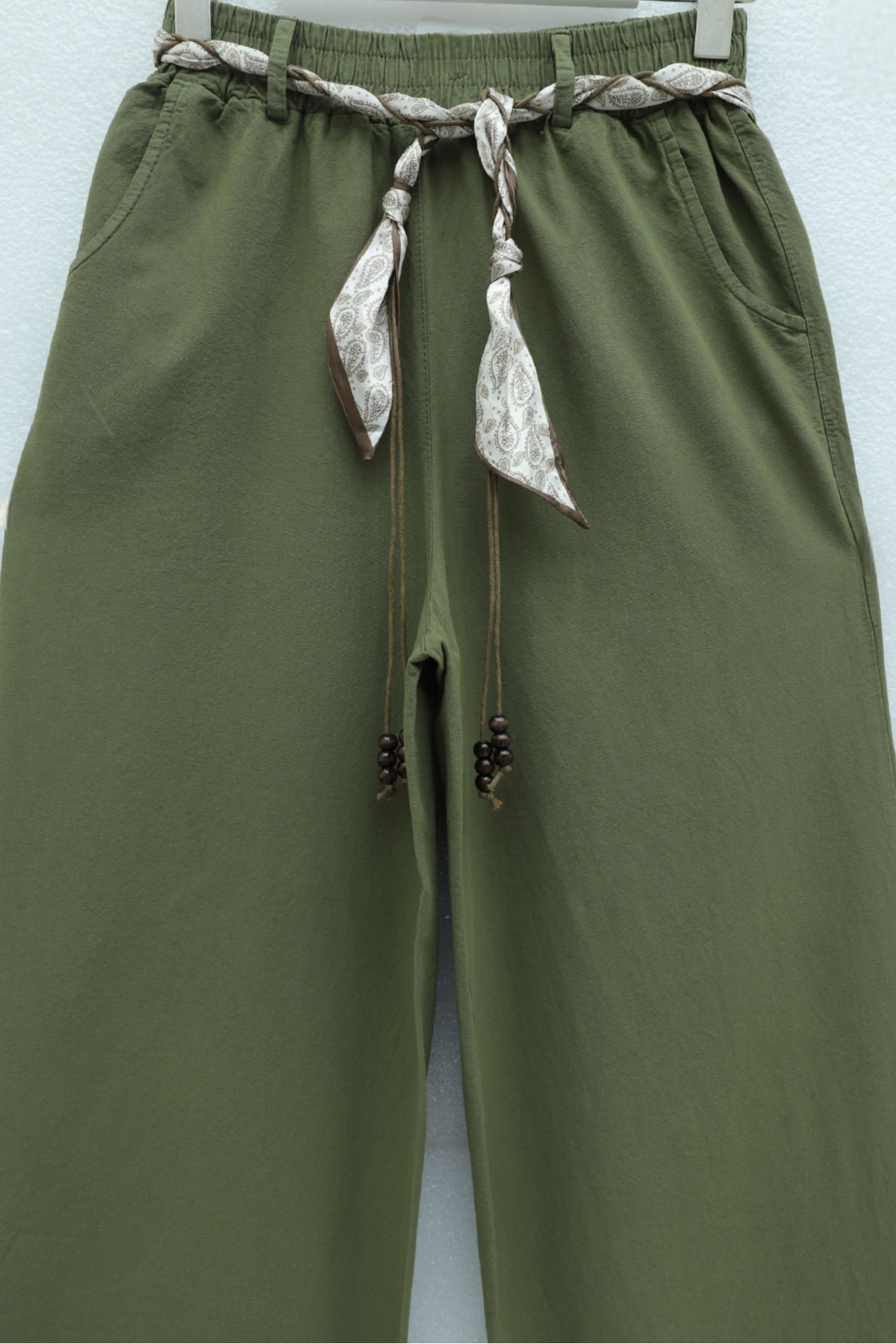 Wide-leg linen trousers with elasticated waist, belt, and pockets. -Khaki