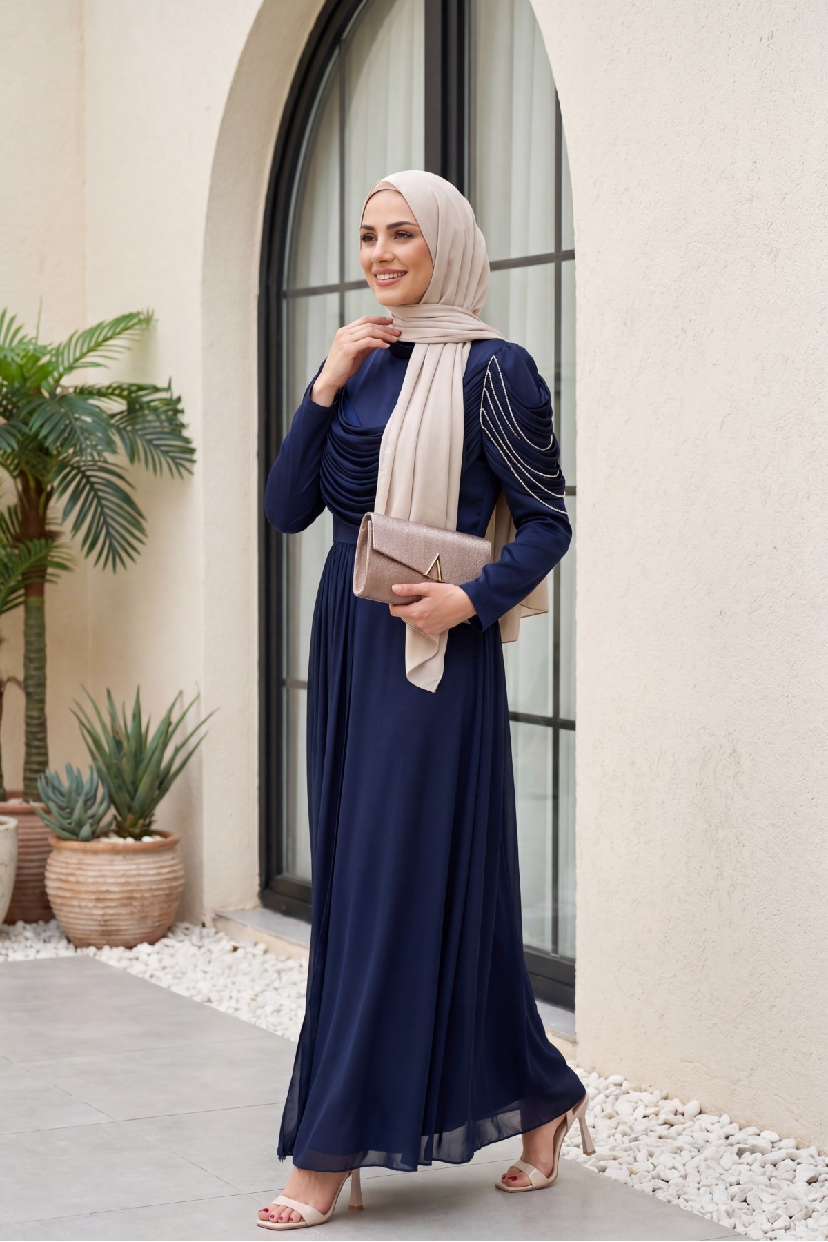 Front-facing, shoulder-embellished, shimmering chiffon detail satin evening gown. -Navy blue