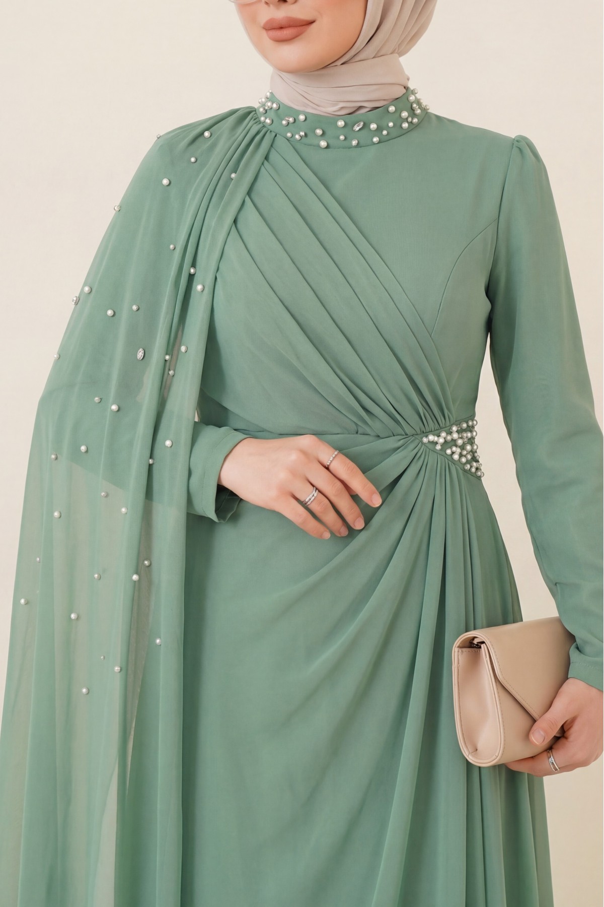 High-neck evening gown with pearl detail and tulle cape. -Cagla Green
