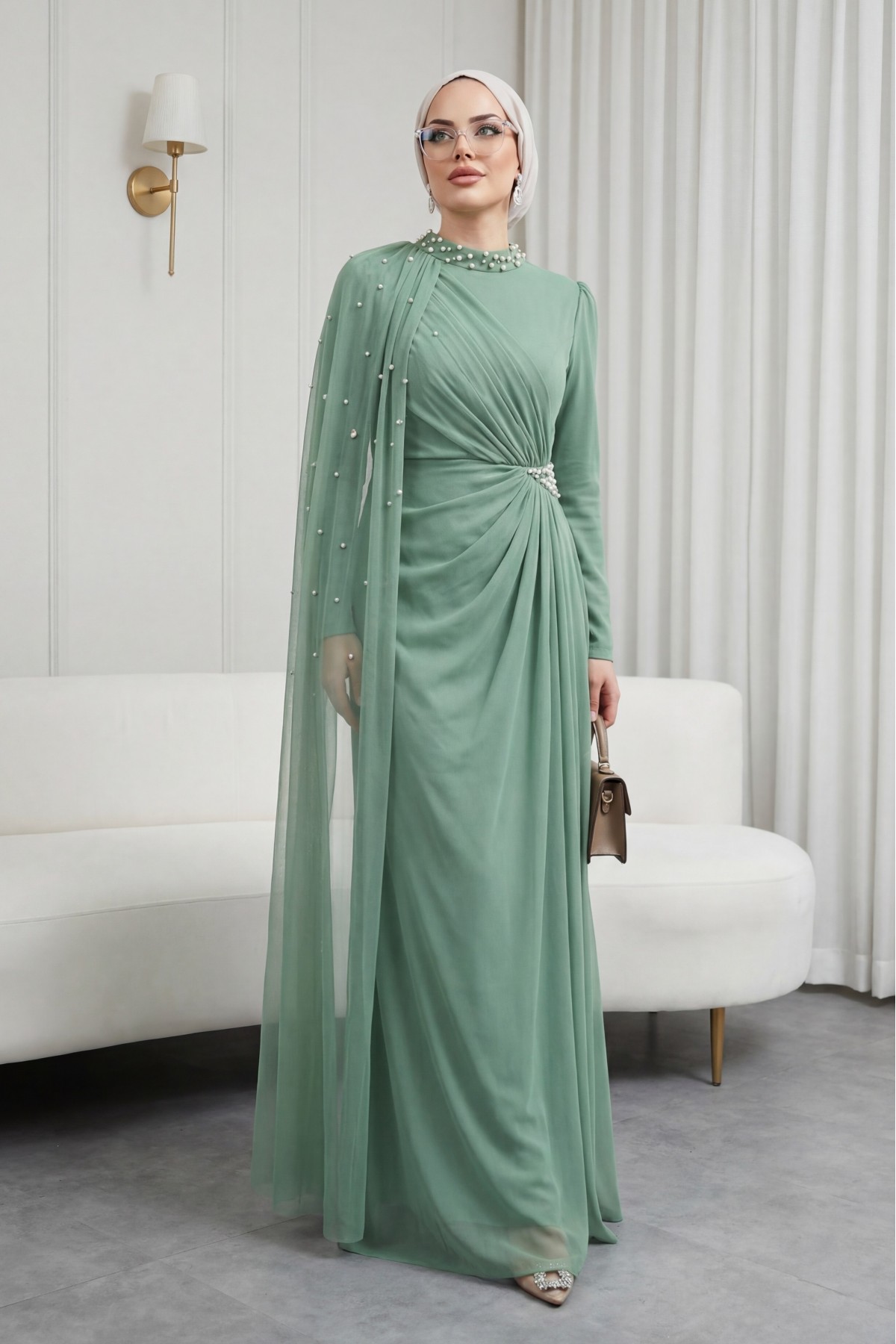 High-neck evening gown with pearl detail and tulle cape. -Cagla Green