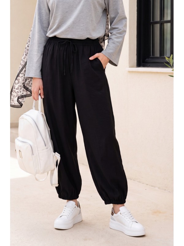 Modal trousers with elasticated waistband, pockets, and drawstring. -Black